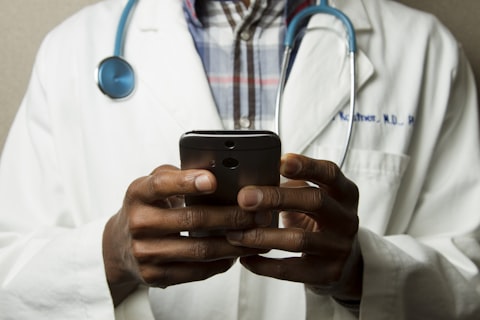 Clinician reviewing notes on a tablet in a clinic setting