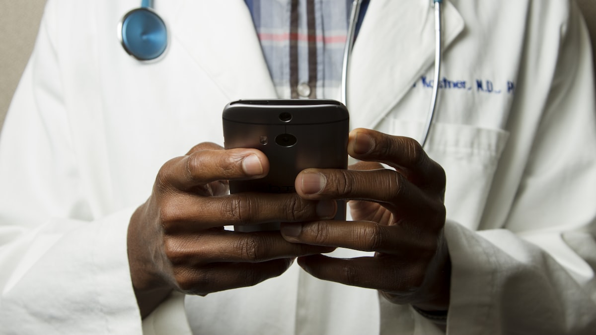 Clinician reviewing notes on a tablet in a clinic setting